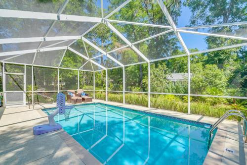 an indoor swimming pool with a glass roof at 4 Mi to Rainbow Springs Dunnellon Home with Pool! in Dunnellon
