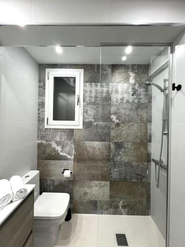 a bathroom with a shower and a toilet and a sink at Apartamento céntrico con terraza EBI02919 in Portugalete