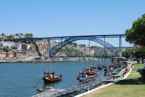 a group of boats docked in the water under a bridge at KING SIZE Bed with Air Conditioning near the BEACH & FREE Street Parking in Canidelo