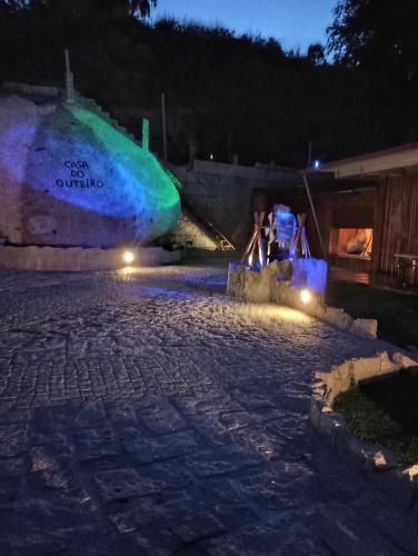 a night view of a stone patio with lights at Casa do Outeiro in Arcos de Valdevez