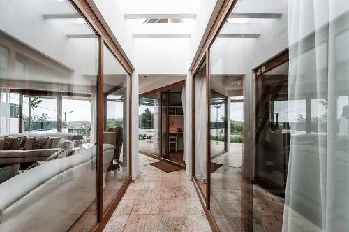 a hallway with glass doors and a living room at Casa de São José in Sintra