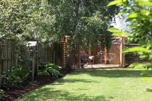 a garden with a wooden fence and a gate at Garden Studio in Biggar in Biggar