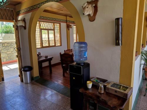 a room with a refrigerator with a water tank on it at Quinta maría isabel. Elegante y restaurada in Gualaceo
