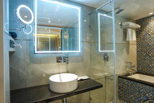 a bathroom with a sink and a glass shower at InstaFeel Hotel in Navi Mumbai