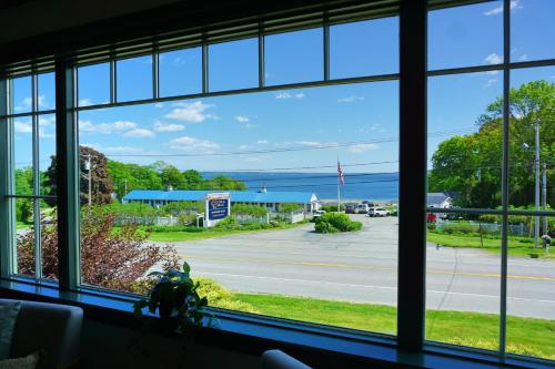 a window with a view of a street and the ocean at Seascape Motel & Cottages in Belfast