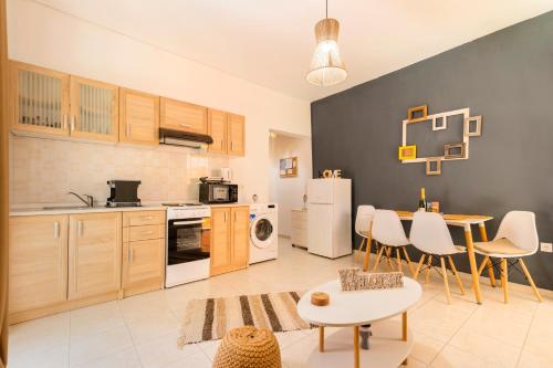 a kitchen with wooden cabinets and a table and chairs at Lilliput Garden in Rhodes Town