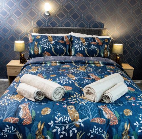 a bed with pillows and towels on it at Ye Olde Vaults in Ashbourne