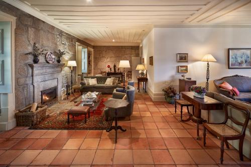 a living room with a fireplace and a stone wall at Solar de Vilar Seco in Vilar Seco