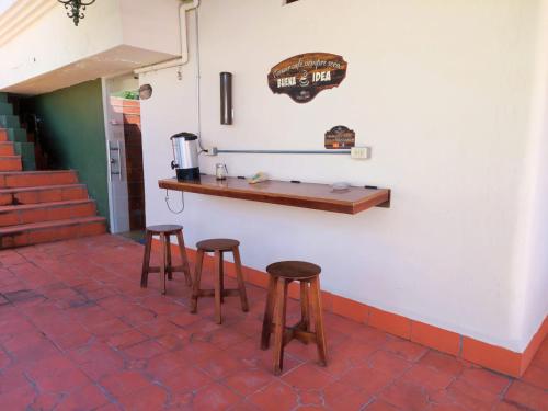 un bar con dos taburetes y un mostrador en una pared en Quinta maría isabel. Elegante y restaurada, en Gualaceo