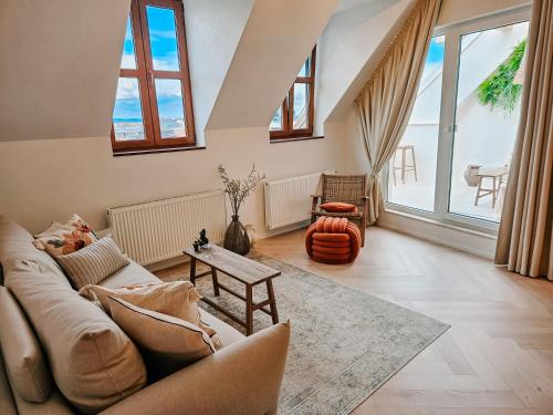 a living room with a couch and a table at NEW Design Top-Class Suite next to the Castle-Free Parking-Terrace in Bratislava