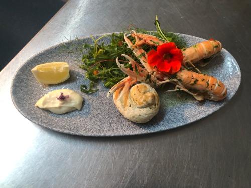 a plate of food with carrots and vegetables on a table at Borgie Lodge Hotel in Borgie