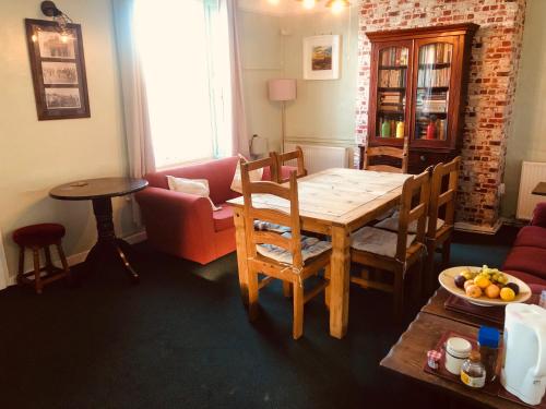 a living room with a dining room table and a couch at Hope & Anchor, Hadrian's Wall, Port Carlisle, Solway Firth, Area of Natural Beauty in Port Carlisle