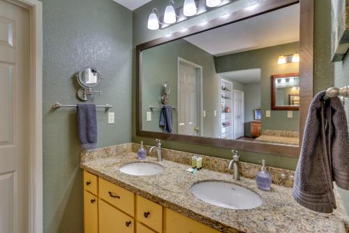 a bathroom with two sinks and a large mirror at Pet-Friendly Escape with Game Room and Fire Pit! in North Fork