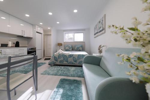 a living room with a couch and a bed at Moradia Chicharro in Nazaré