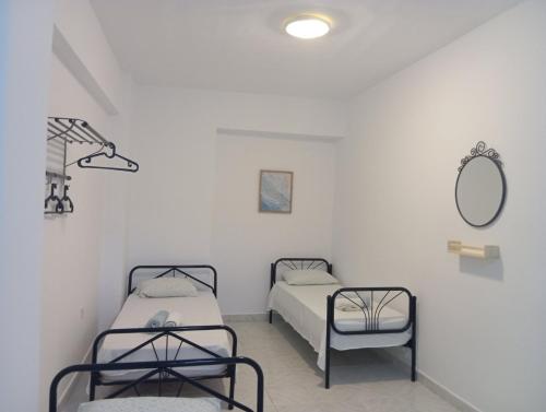 Postel nebo postele na pokoji v ubytování Sirocco Seaside