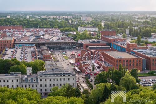 an aerial view of a city with a ferris wheel at Manu Park I by LookAp Parking Gratis in Łódź