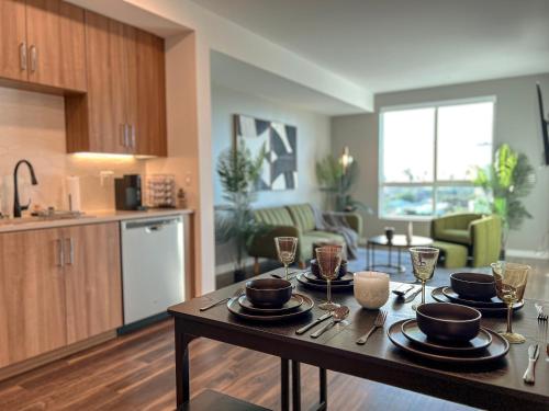 a kitchen and living room with a table with plates and glasses at Luxurious Hollywood Home City View - Free Parking 10mins to Universal Studios in Los Angeles