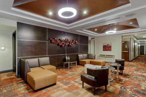 a lobby with couches and chairs and a table at Best Western Premier Denham Inn & Suites in Leduc