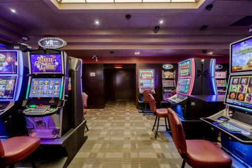 a casino with several slot machines in a room at Best Western Premier Denham Inn & Suites in Leduc