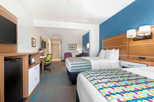 a hotel room with two beds and a television at Best Western Plus Medical Center in Amarillo
