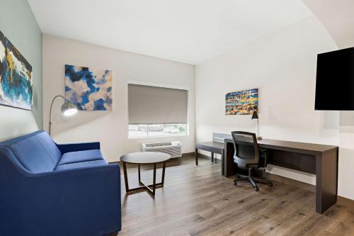 an office with a blue chair and a desk and a keyboard at Best Western Iowa - Lake Charles East in Iowa