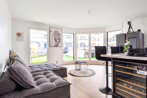 a living room with a couch and a table at Résidence Abraham-Guest Room 1 LaDéfense U-Arena #Terasse #Fibre #View in Colombes