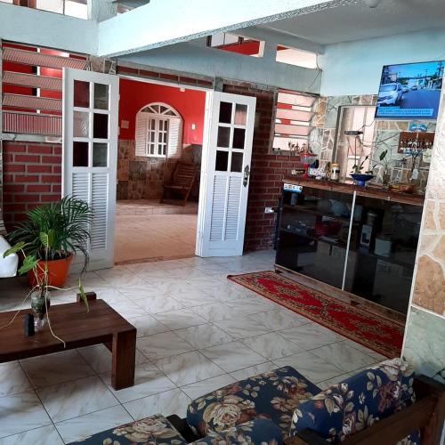 a living room with a couch and a table at Pousada Canto de Guarajuba in Camacari