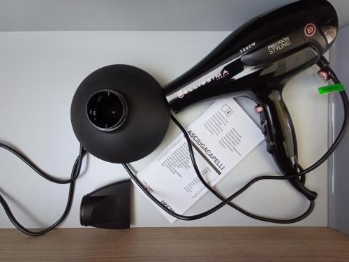 a pair of headphones hanging on a wall at Notte di Note - home hospitality in Busto Arsizio