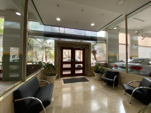 a lobby of a car dealership with chairs and a door at Tigre Center Tower i - Con piscina y seguridad 24hs - Opcional cochera in Tigre