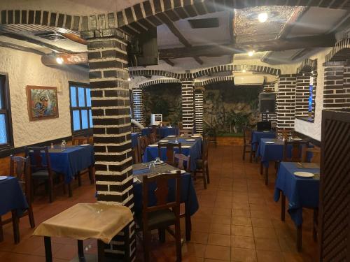 a restaurant with blue tables and chairs in a room at Hotel brisas del mar 2022 in Catia La Mar