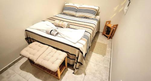Un pat sau paturi într-o cameră la Espaço do acalanto