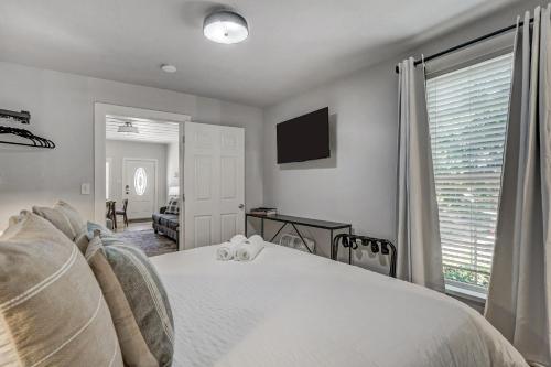 a bedroom with a white bed and a window at Neighborly Heights - Downtown King BBQ Fire Pit in Colorado Springs