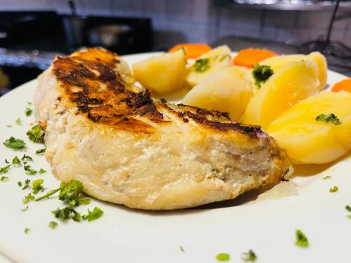a plate of food with a piece of meat and potatoes at Hotel brisas del mar 2022 in Catia La Mar