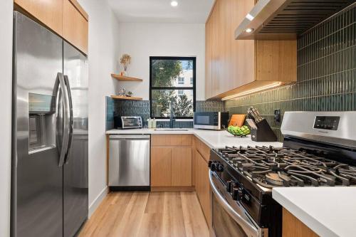a kitchen with a stove and a refrigerator at Rooftop 3B 3BA House Near Dodger Stadium and DTLA in Los Angeles