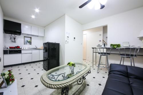 a kitchen and living room with a couch and a table at 3, Kameido, Entire house for rent, 亀戸 in Tokyo