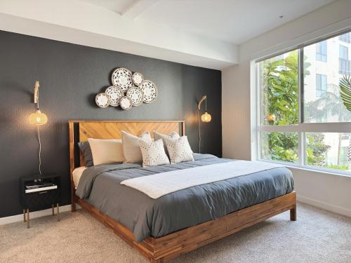 a bedroom with a large bed and a window at Spacious Hollywood Home Sunset View-Free Parking 10mins to Universal Studios in Los Angeles