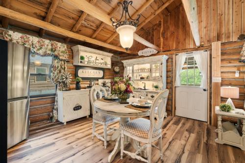 a kitchen with wooden walls and a table and chairs at Spring Hill Farm - The Pampered Peacock in Alma