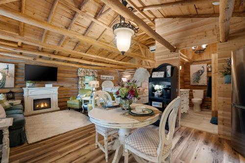 a living room with a table and a fireplace at Spring Hill Farm - The Pampered Peacock in Alma