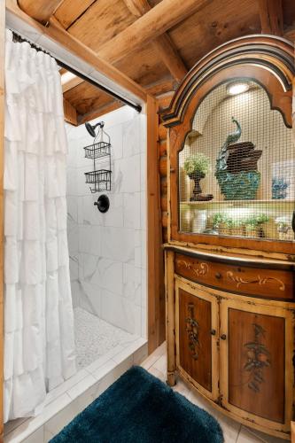 a bathroom with a shower with a wooden ceiling at Spring Hill Farm - The Pampered Peacock in Alma