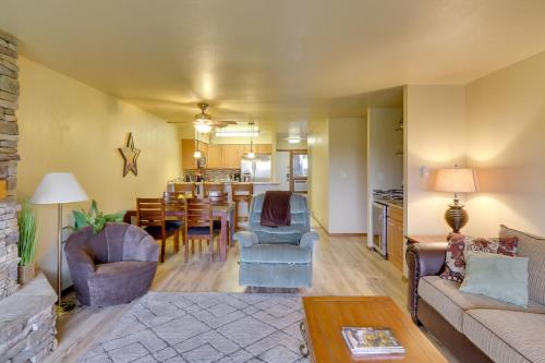 a living room with a couch and a dining room at Bigfork Condo with Hot Tub Access, By Lake! in Bigfork