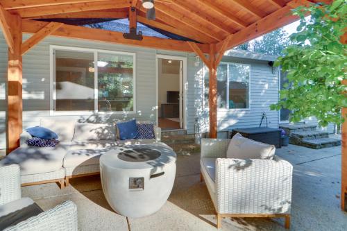 a screened in porch with a couch and chairs at Beautiful Pet-Friendly Washougal Home with Fire Pit! in Washougal