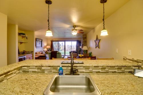 a kitchen with a sink and a counter top at Bigfork Condo with Hot Tub Access, By Lake! in Bigfork