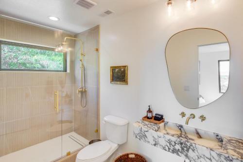 a bathroom with a shower and a toilet and a mirror at Luxe Retreat with Theater Room Walk to Bear Lake! in Garden City