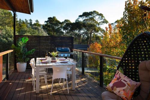 a patio with a table and a grill on a deck at Away - 4 bedroom 2 bathroom family home in Daylesford