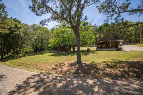 a tree in the middle of a field with a gazebo at Spring Hill Farm - The Velvet Rooster in Alma
