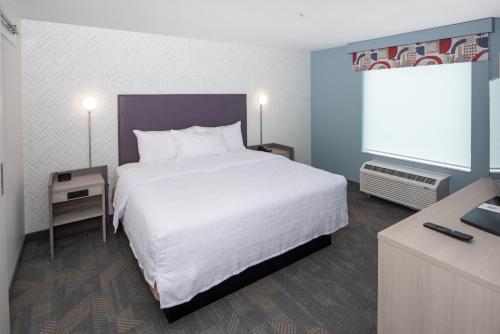 a bedroom with a large white bed and a window at Home2 Suites By Hilton East Haven New Haven in East Haven