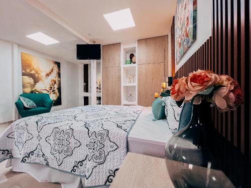 a bedroom with a bed and a vase with flowers in it at Hotel San Angelo in Concepción de Ataco
