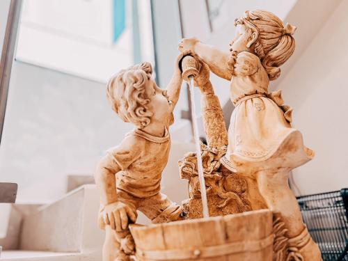 a statue of two children playing in a basket at Hotel San Angelo in Concepción de Ataco
