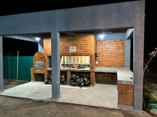 a brick building with a counter in the middle at Casa La Olguita in Vista Flores