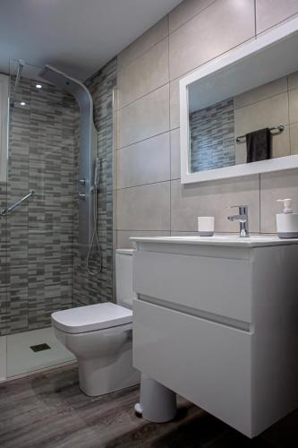 a bathroom with a sink and a toilet and a shower at Casa Mayte in O Grove